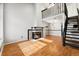 Bright living room with fireplace and updated staircase to the second-floor loft at 1885 S Quebec Way # A28, Denver, CO 80231