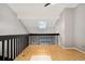 Loft featuring a skylight for natural light, wood floors and black supports at 1885 S Quebec Way # A28, Denver, CO 80231