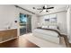 Spacious main bedroom featuring a ceiling fan, hard wood floors and a sliding door leading to a balcony at 1885 S Quebec Way # A28, Denver, CO 80231
