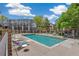 A refreshing outdoor pool with lounge chairs and lush landscaping surrounded by condos at 1885 S Quebec Way # A28, Denver, CO 80231