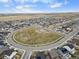 Aerial view of neighborhood showing houses surrounding community green space under a blue sky at 27674 E 7Th Dr, Aurora, CO 80018