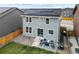 Aerial view of house with solar panels, fenced yard, and patio at 27674 E 7Th Dr, Aurora, CO 80018