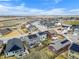 Neighborhood aerial view showing houses with solar panels and fenced yards on a sunny day at 27674 E 7Th Dr, Aurora, CO 80018