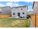 Spacious backyard with patio, seating, and well-maintained lawn at 27674 E 7Th Dr, Aurora, CO 80018