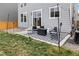Cozy backyard patio with stylish outdoor rug, seating, and string lights at 27674 E 7Th Dr, Aurora, CO 80018