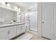 Bathroom featuring double vanity and large walk-in shower with glass enclosure at 27674 E 7Th Dr, Aurora, CO 80018