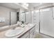 Bathroom featuring double vanity and large walk-in shower with glass enclosure at 27674 E 7Th Dr, Aurora, CO 80018
