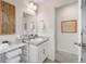 Bathroom featuring a vanity with a sink, a large mirror, and a window at 27674 E 7Th Dr, Aurora, CO 80018