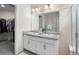 Bathroom featuring double vanity, walk-in shower, and large walk-in closet at 27674 E 7Th Dr, Aurora, CO 80018