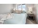 Sun-drenched bedroom with plush bedding, side tables, and bright windows at 27674 E 7Th Dr, Aurora, CO 80018