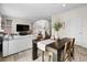 Bright dining area featuring modern table, neutral color palette and seamless transition to the living space at 27674 E 7Th Dr, Aurora, CO 80018
