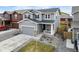 Two-story home with grey siding, stone accents, and well-maintained landscaping at 27674 E 7Th Dr, Aurora, CO 80018