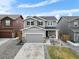 Beautiful two-story home featuring an attached garage, a manicured lawn, and a welcoming entryway at 27674 E 7Th Dr, Aurora, CO 80018