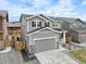 Charming two-story home with grey siding, stone accents, and well-maintained landscaping at 27674 E 7Th Dr, Aurora, CO 80018