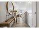 Bright foyer with hardwood floors, decorative table, and a glimpse into the living room at 27674 E 7Th Dr, Aurora, CO 80018