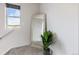 Upstairs hallway featuring a decorative mirror and lush potted plant adding a touch of greenery at 27674 E 7Th Dr, Aurora, CO 80018