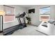 Home gym with treadmill and work-from-home setup with natural lighting at 27674 E 7Th Dr, Aurora, CO 80018