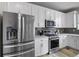 Modern kitchen featuring stainless steel appliances, light countertops, and ample cabinet space at 27674 E 7Th Dr, Aurora, CO 80018