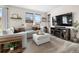 Cozy living room with a large sofa, tv, and natural light, creating a relaxing space at 27674 E 7Th Dr, Aurora, CO 80018