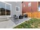 Cozy patio area with seating, grill, and stylish outdoor rug at 27674 E 7Th Dr, Aurora, CO 80018