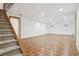 Unfurnished basement showing stairway, vinyl flooring, recessed lighting, and windows at 4720 S Grant St, Englewood, CO 80113