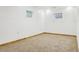 Unfinished basement with carpet and two windows provides ample opportunity for customization at 4720 S Grant St, Englewood, CO 80113
