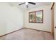 Neutral bedroom with ceiling fan, carpet, wooden trim, and a large window at 4720 S Grant St, Englewood, CO 80113