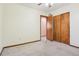 Bedroom with carpet, closet, ceiling fan, and wooden trim at 4720 S Grant St, Englewood, CO 80113