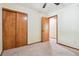 Bedroom with carpet, closet, ceiling fan, and wooden trim at 4720 S Grant St, Englewood, CO 80113