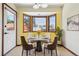 Bright breakfast nook with bay window, tile floor, and seating for four at 4720 S Grant St, Englewood, CO 80113