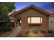 Attractive brick home showcasing a front bay window, fresh landscaping, and covered entry at 4720 S Grant St, Englewood, CO 80113