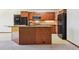 Spacious kitchen featuring wooden cabinets, stone countertops, and modern black appliances at 4720 S Grant St, Englewood, CO 80113