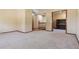 Spacious room featuring plush carpeting, staircase, and opening to the piano room at 4720 S Grant St, Englewood, CO 80113