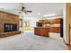 Bright and airy living space featuring a brick fireplace, kitchen access, and cozy seating at 4720 S Grant St, Englewood, CO 80113