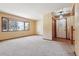 Spacious living room features a large bay window and neutral-colored carpeting at 4720 S Grant St, Englewood, CO 80113