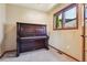 Cozy room featuring a classic piano, natural light, and carpeted flooring at 4720 S Grant St, Englewood, CO 80113