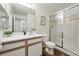 Modern bathroom with wood-look floors, a white vanity, walk-in shower with glass doors and tile at 7489 S Quail Cir # 814, Littleton, CO 80127