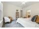Cozy bedroom featuring a chair, large windows, and a view to an ensuite bathroom at 7489 S Quail Cir # 814, Littleton, CO 80127