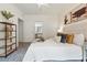 Bright bedroom featuring a white bedspread, decorative pillows, neutral walls and shelf with plants at 7489 S Quail Cir # 814, Littleton, CO 80127