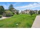 View of the community with green grass, mature trees, and attractive multi-story buildings at 7489 S Quail Cir # 814, Littleton, CO 80127