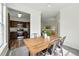 Bright dining area features a wooden table and seating adjacent to a well-appointed kitchen at 7489 S Quail Cir # 814, Littleton, CO 80127