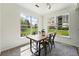 Sunlit dining room featuring a rustic table, metal chairs, and large windows at 7489 S Quail Cir # 814, Littleton, CO 80127