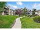 Attractive condo building with manicured lawn and walkway on a sunny day at 7489 S Quail Cir # 814, Littleton, CO 80127