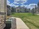 Condo building with a well-maintained lawn and sidewalk access on a sunny day at 7489 S Quail Cir # 814, Littleton, CO 80127