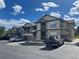 Modern condo building featuring stone accents, private balconies, and visitor parking spaces at 7489 S Quail Cir # 814, Littleton, CO 80127