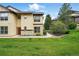 Inviting condo exterior with well-maintained lawn and charming architectural details at 7489 S Quail Cir # 814, Littleton, CO 80127