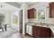 Bright kitchen featuring stainless steel appliances, wooden cabinets, and a view from a sunny window at 7489 S Quail Cir # 814, Littleton, CO 80127