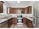 This kitchen offers stainless steel appliances, wooden cabinets and countertops and a kitchen sink with a window at 7489 S Quail Cir # 814, Littleton, CO 80127
