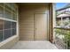 Cozy covered patio with neutral siding, black railing, and a storage closet at 7489 S Quail Cir # 814, Littleton, CO 80127