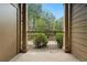 Covered patio with decorative pillars and railing overlooking a landscaped area with trees and shrubs at 7489 S Quail Cir # 814, Littleton, CO 80127